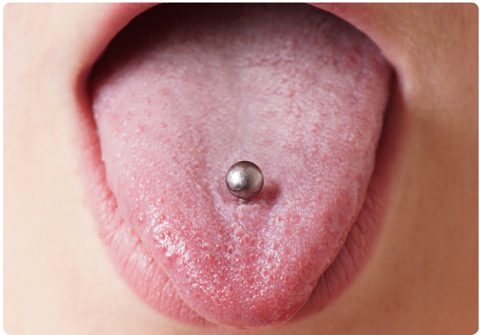 Close-up of a tongue piercing with a metal stud
